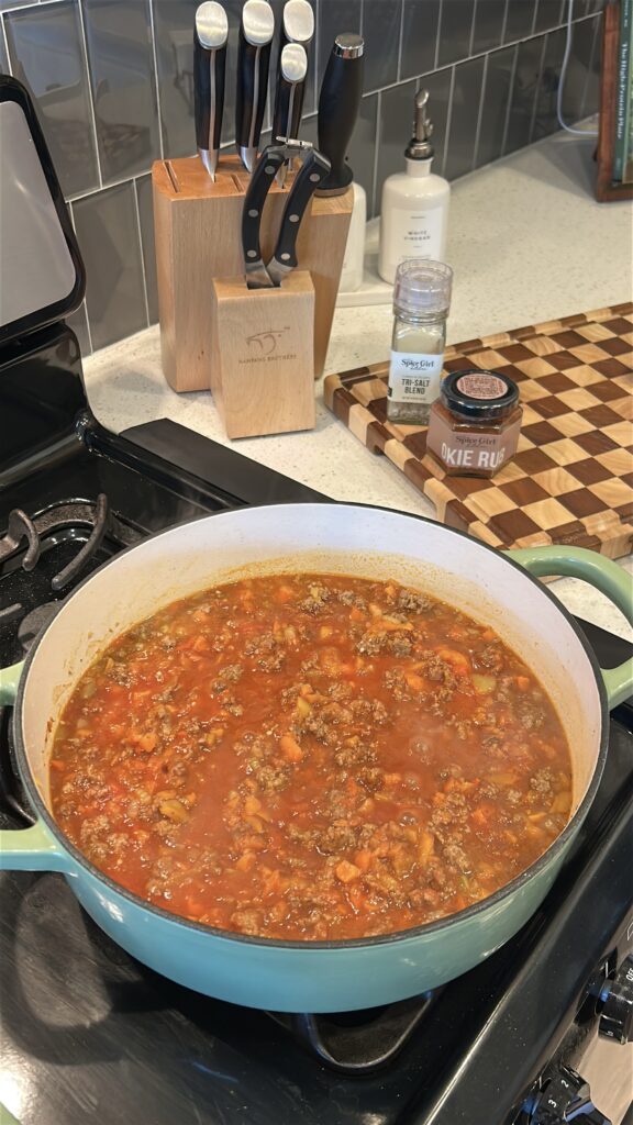 Adding sauce ingredients to sloppy joe mixture