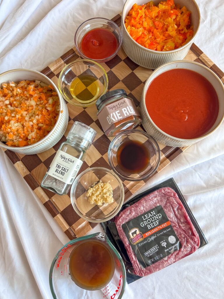 Ingredients for healthy sloppy joes including ground beef, vegetables, and sauce