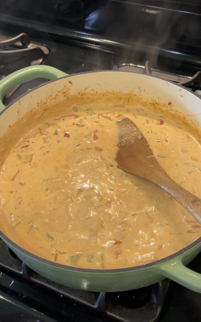 Creamy Cajun Parmesan sauce simmering in a skillet