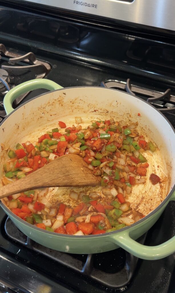 Bell peppers and onions sautéed for creamy Cajun chicken pasta