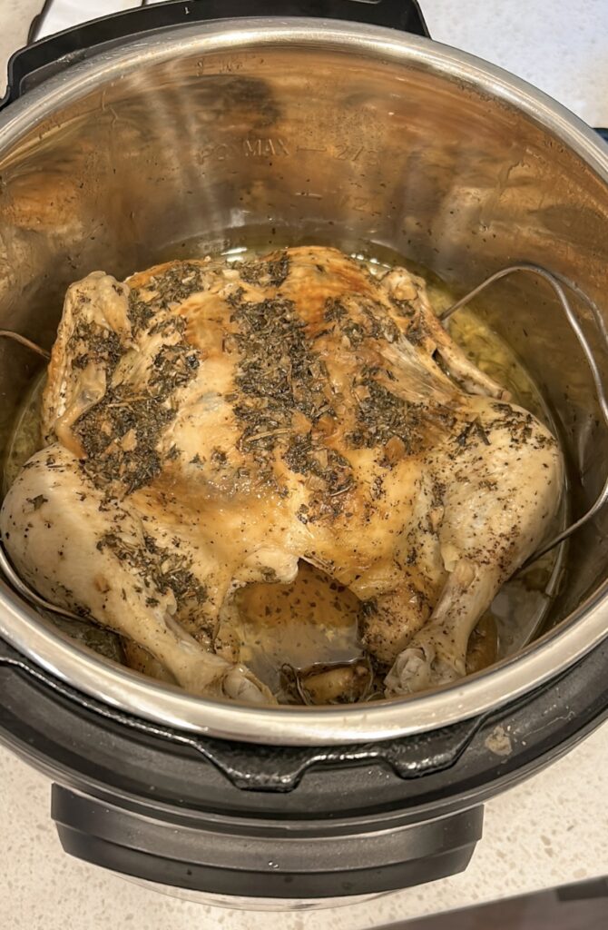 Fully cooked Instant Pot whole chicken before broiling for crispy skin