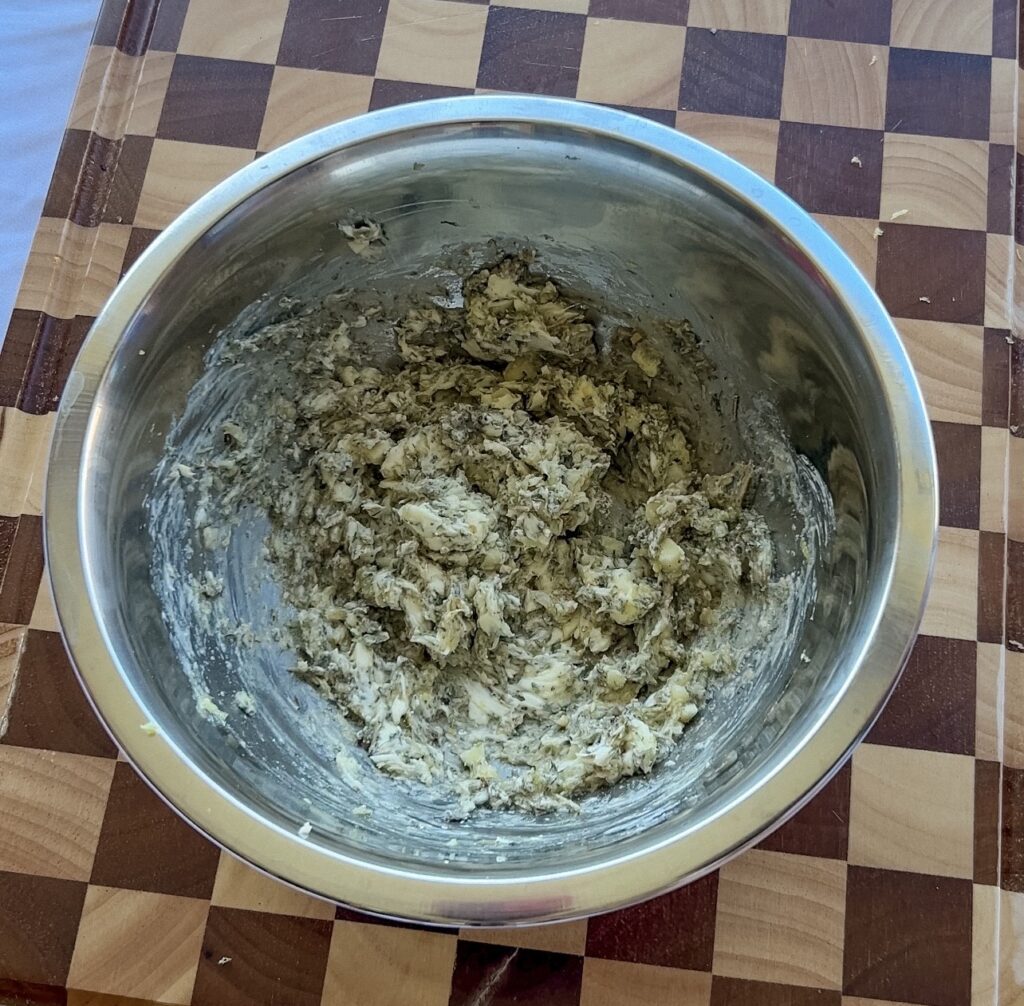 Mixing honey, butter, garlic, and Herbs de Provence to make the chicken seasoning butter