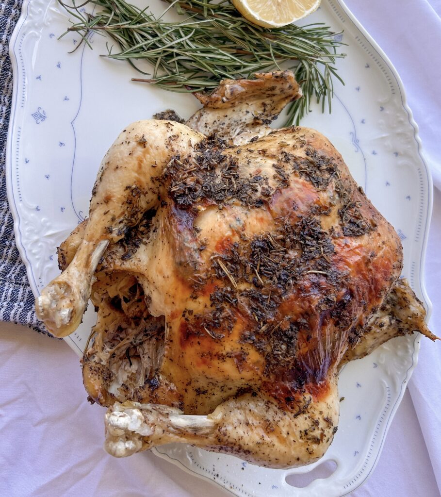Instant Pot Whole Chicken with honey and Herbs de Provence served on a platter with crispy golden skin