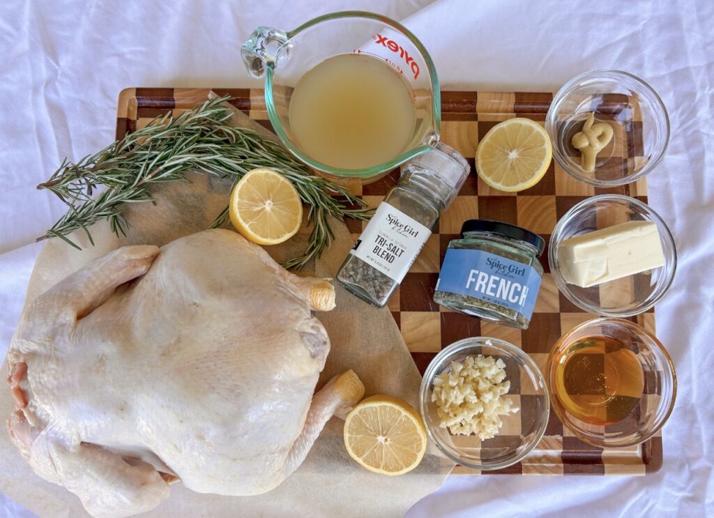 Ingredients for Instant Pot Whole Chicken including whole chicken, honey, butter, French Seasoning, garlic, lemon, rosemary, Dijon mustard, and chicken broth