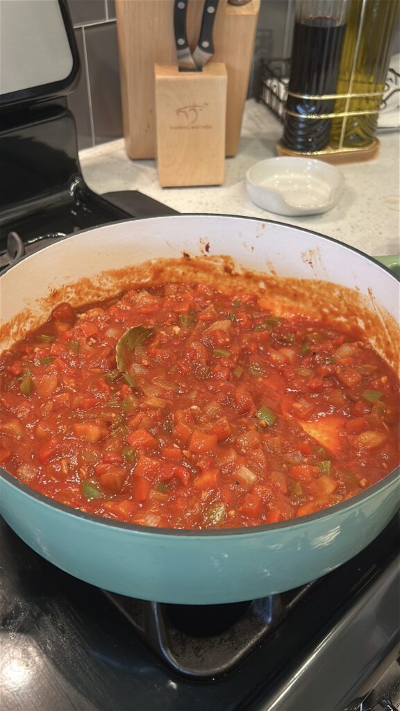 Tomato sauce, tomato paste, vino seco, and seasonings combined to make camarones enchilados sauce