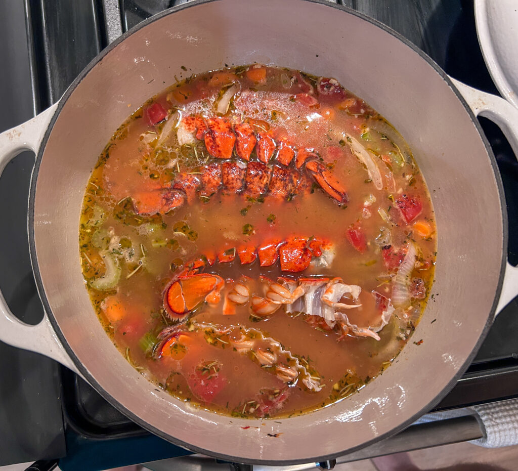 adding broth, and lobster shells to bisque