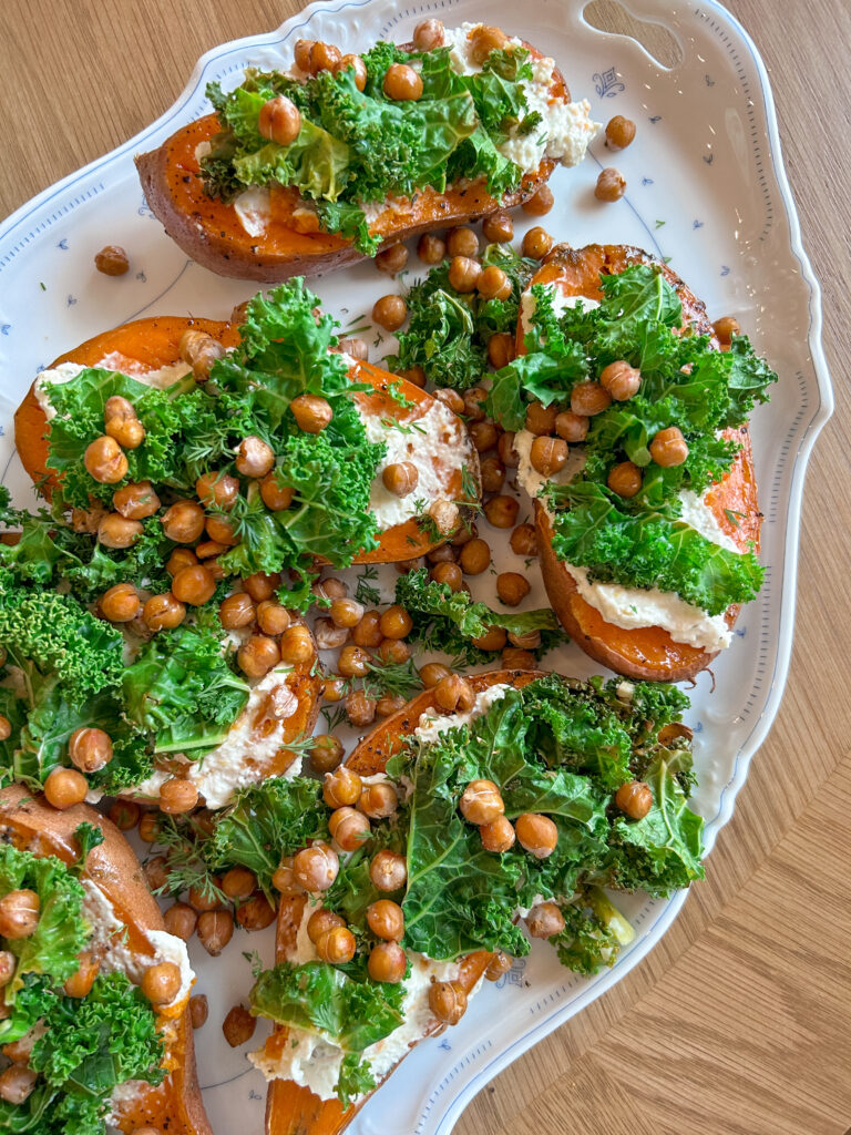 assembling sweet potato boats with feta kale and chickpeas