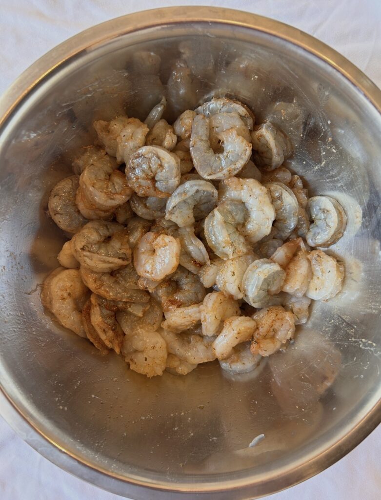 Shrimp coated with Cajun seasoning before cooking