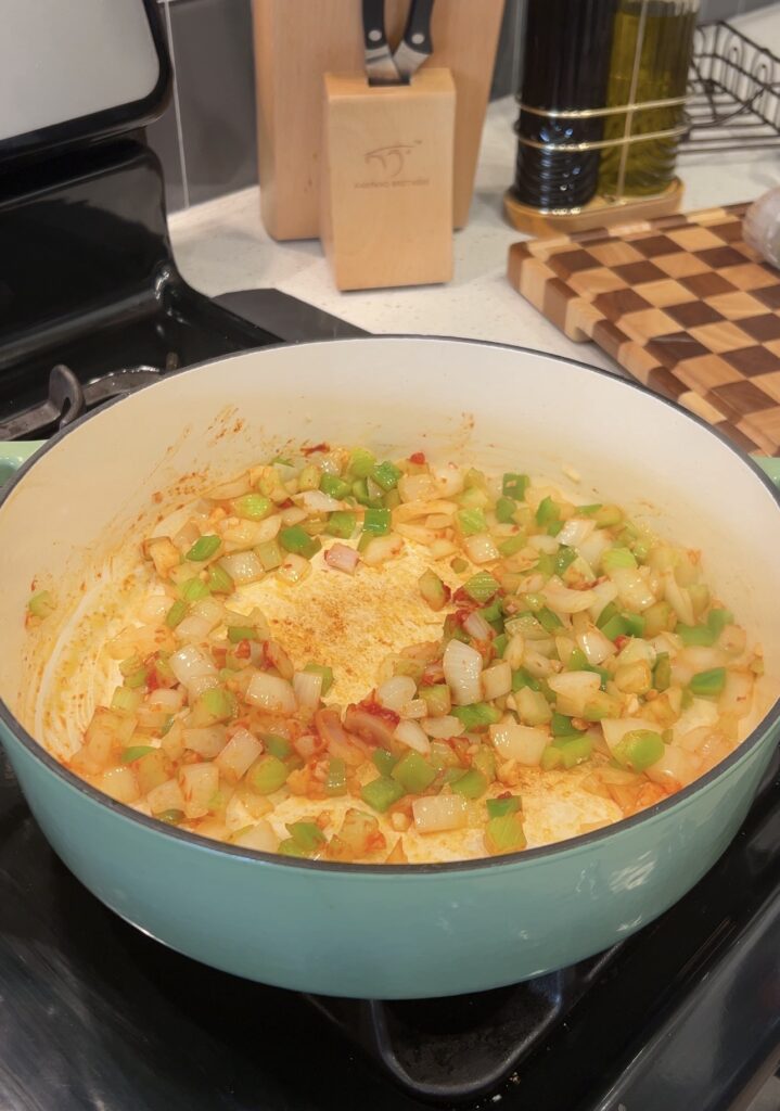 Onion, celery, and bell pepper cooking for Shrimp Creole