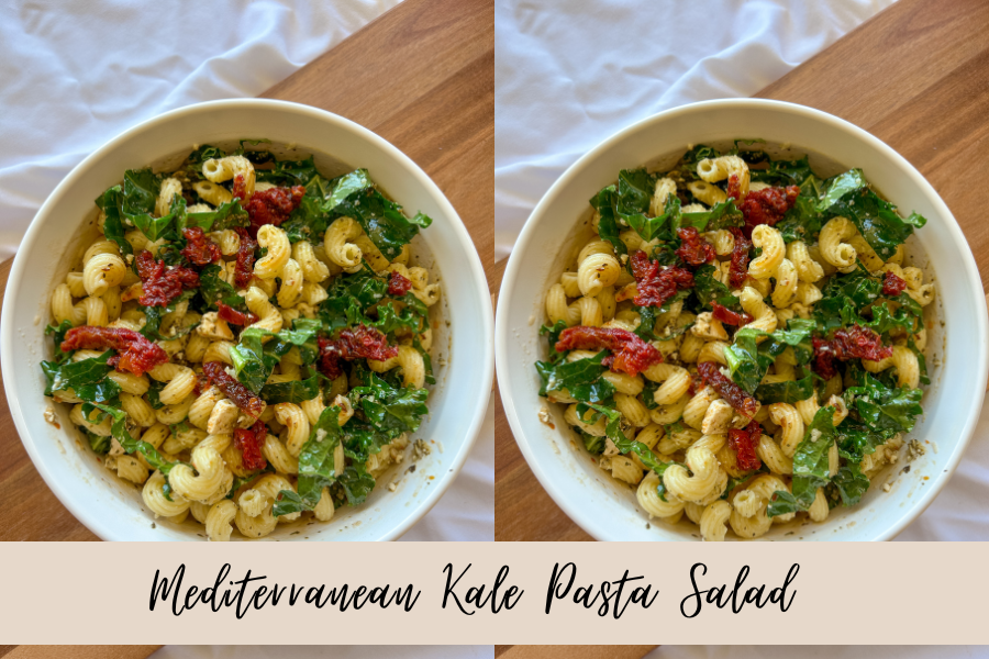 Overhead view of Mediterranean kale pasta salad with kale, feta, and sun-dried tomatoes on a wood surface