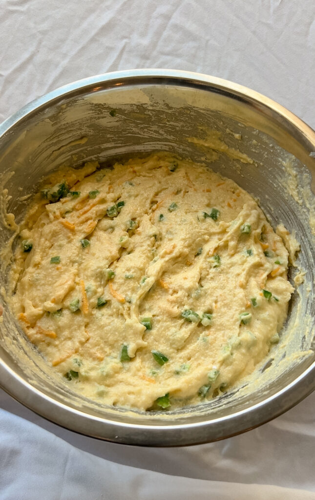 Adding cheddar cheese and jalapeños to cornbread batter