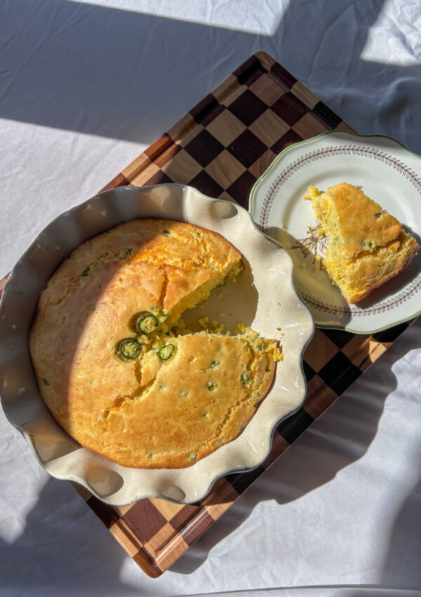 Jalapeño cheddar cornbread baked in 8-inch pie pan with butter melting on top