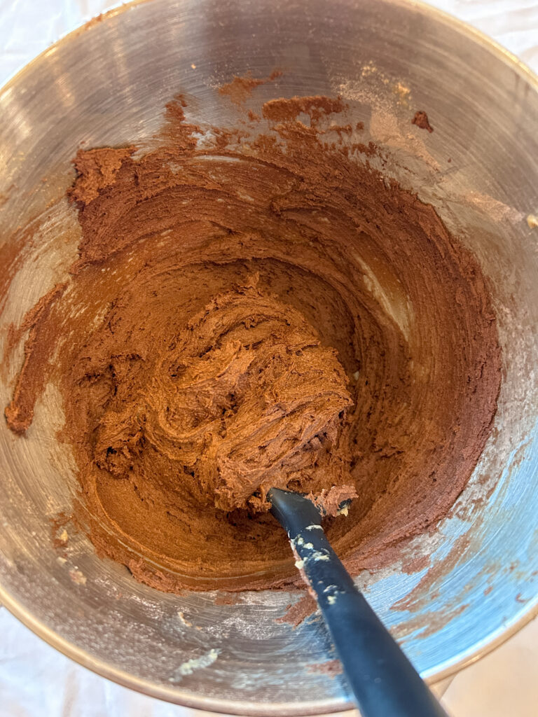 Combining wet and dry ingredients to make rocky road cookie dough base