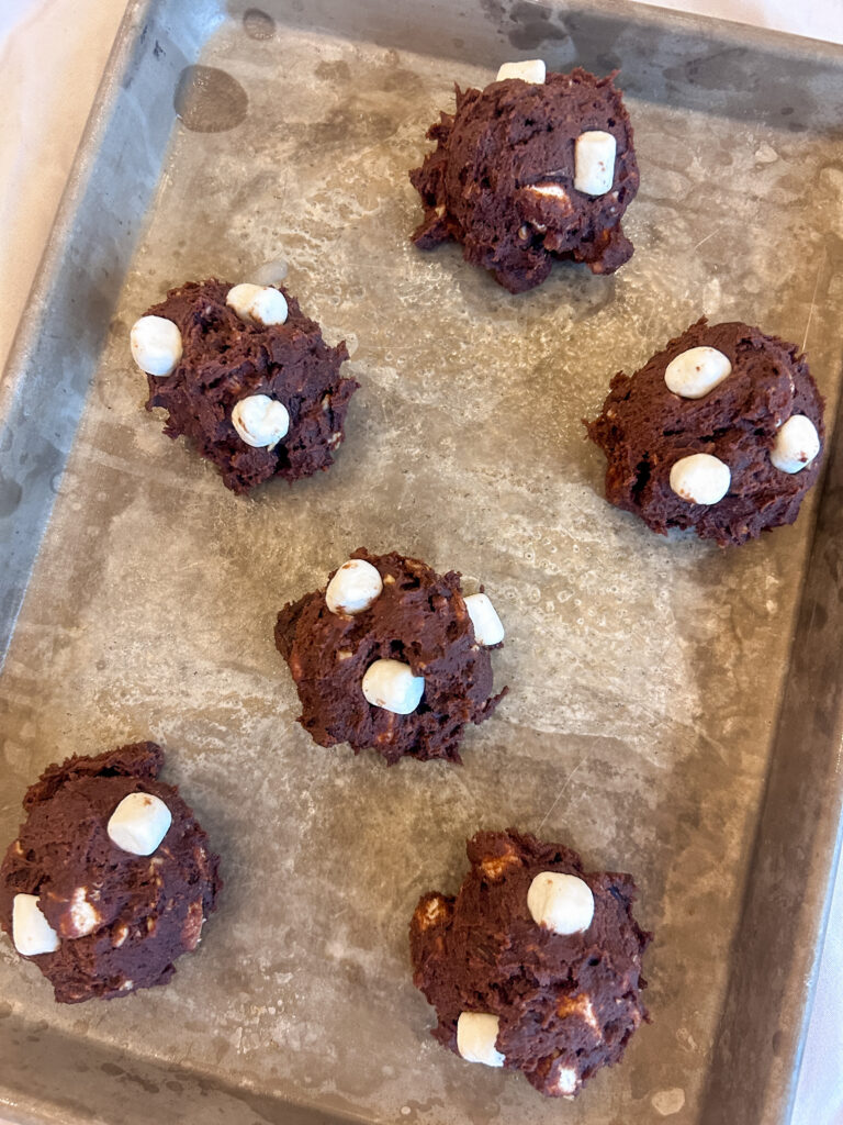Rocky road cookie dough balls on baking tray before baking