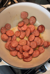 browning andouille sausage in dutch oven for pastalaya