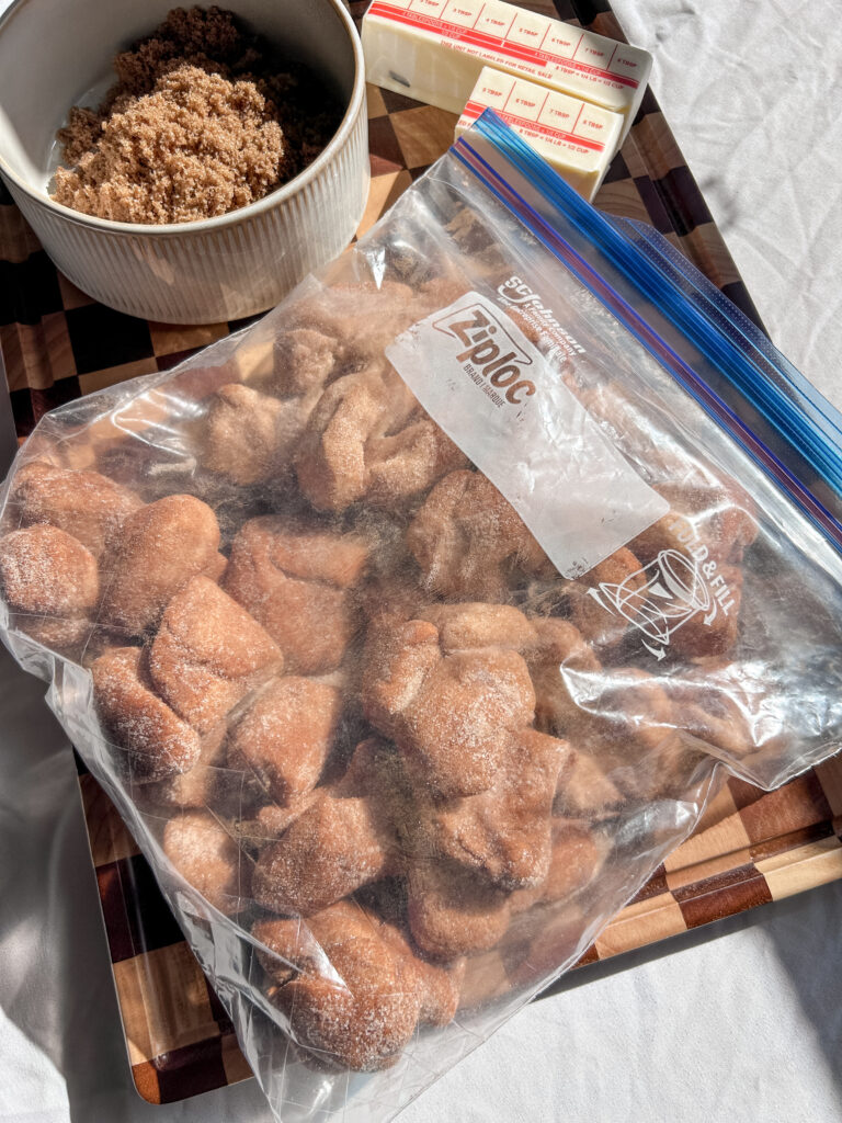 tossing biscuit dough in cinnamon sugar to make cinnamon bites