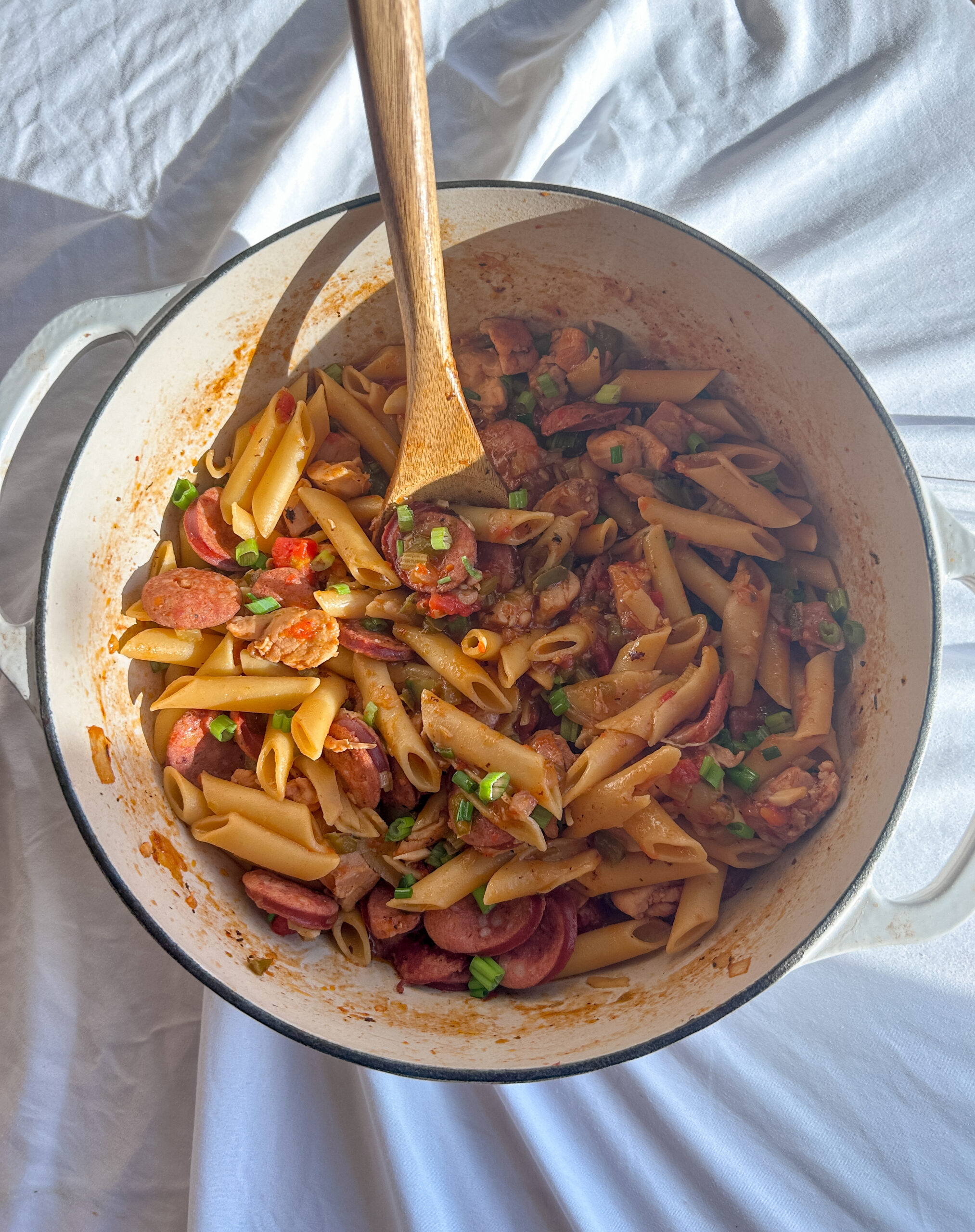 authentic cajun pastalaya in bowl with parsley and green onions