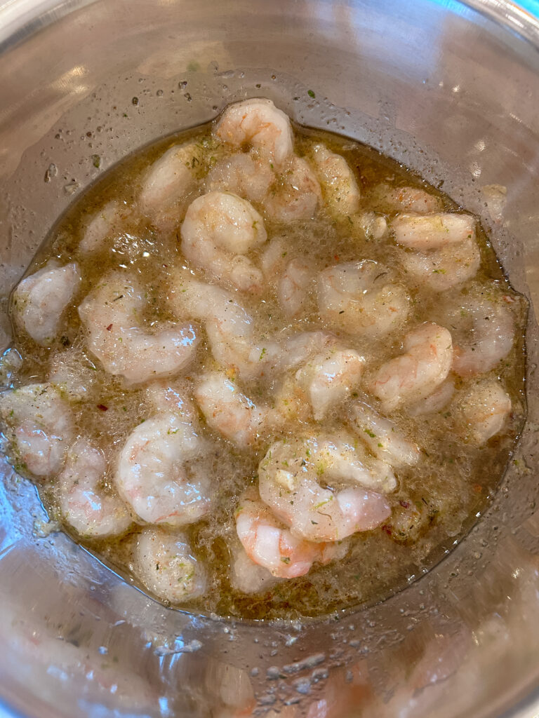 shrimp marinating in jerk seasoning with lime and garlic