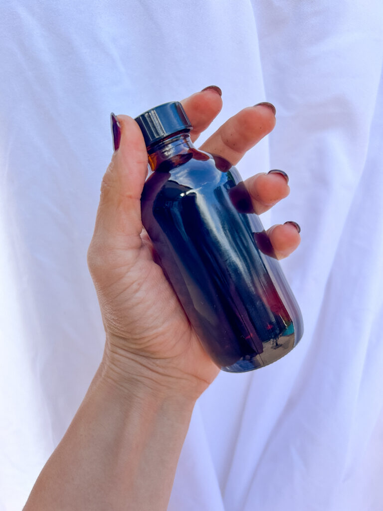 vanilla beans in bottle submerged with whiskey for homemade whiskey vanilla extract