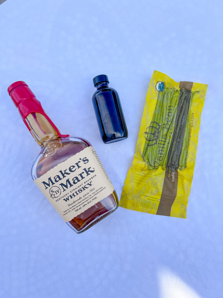ingredients for homemade whiskey vanilla extract on a countertop
