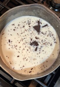 adding chopped chocolate to milk