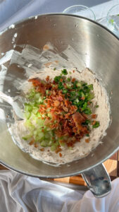 Adding celery, green onion, and bacon