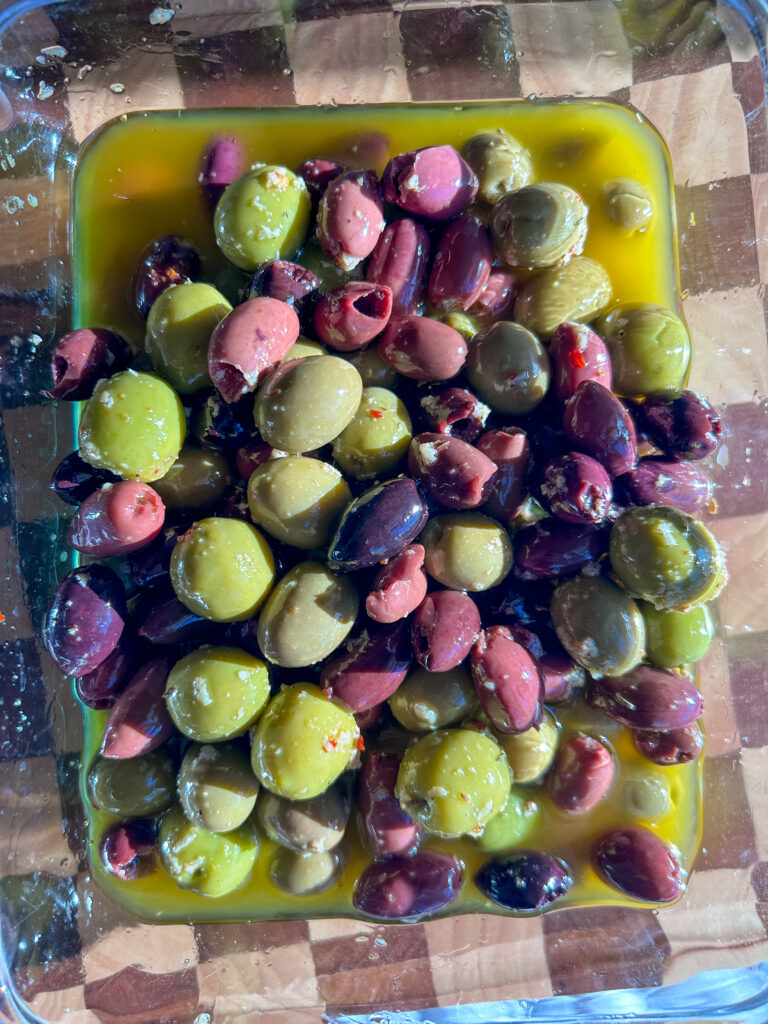 close up of marinated olives with garlic and olive oil
