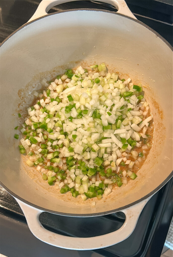 Sweating onion, celery, and bell pepper in a pot for shrimp etouffee