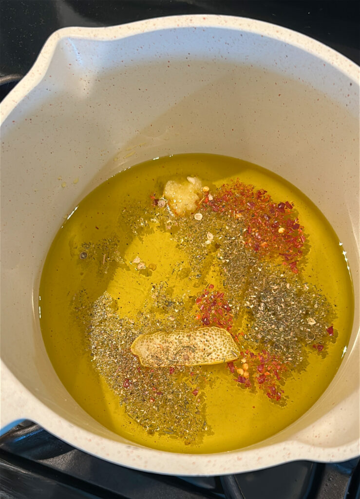warming olive oil with garlic and lemon zest