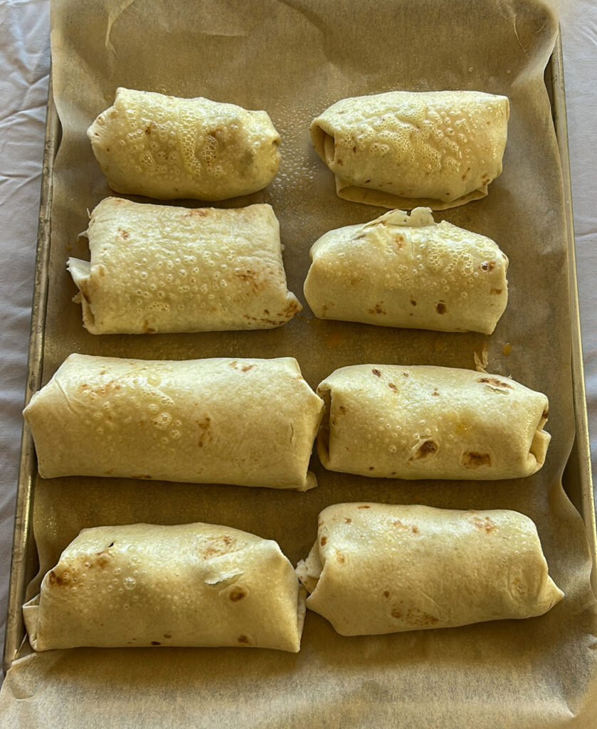 Assembled breakfast burritos before baking