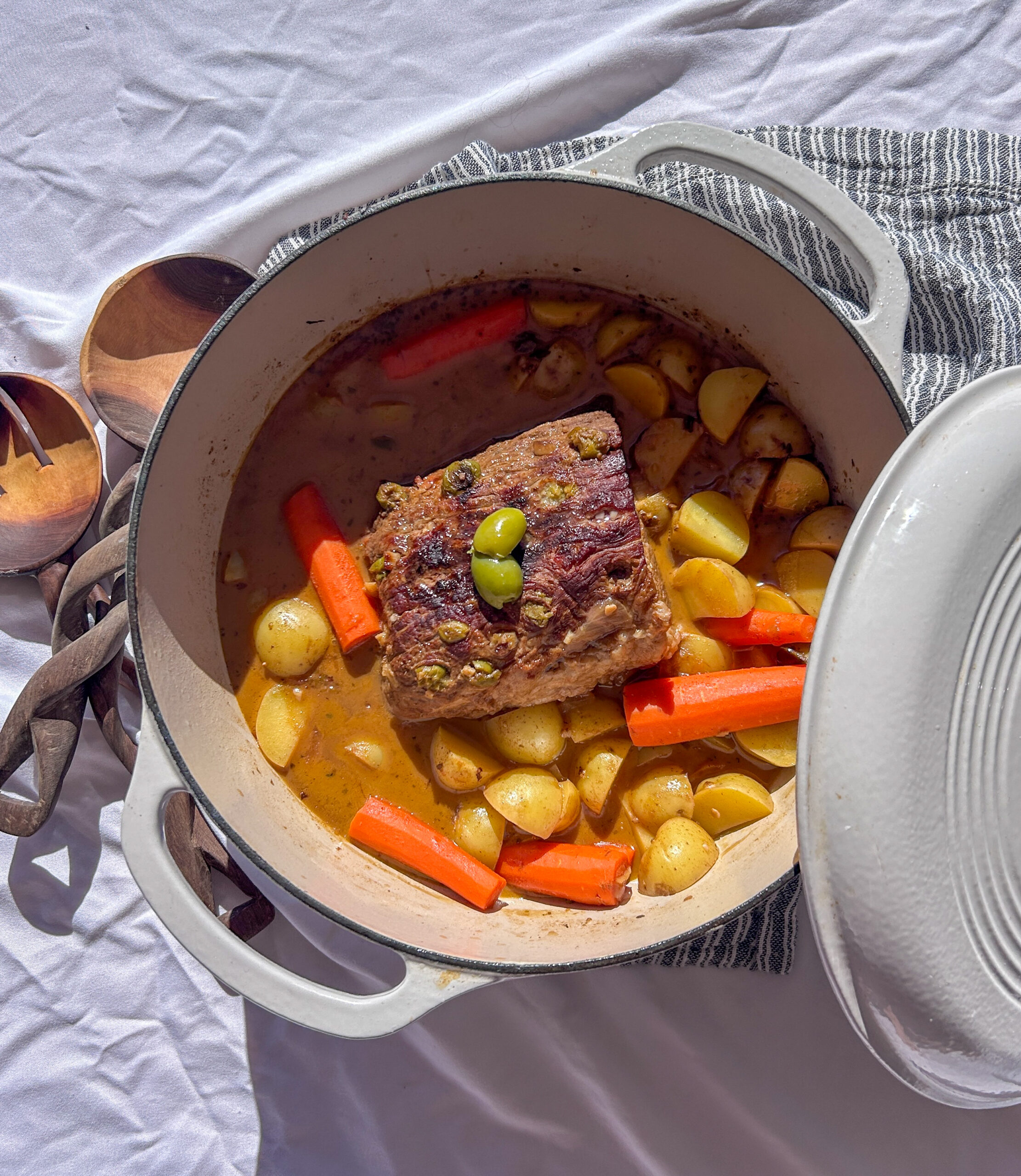 Traditional boliche criollo sliced and served with sauce, a Cuban stuffed pot roast made with eye of round beef