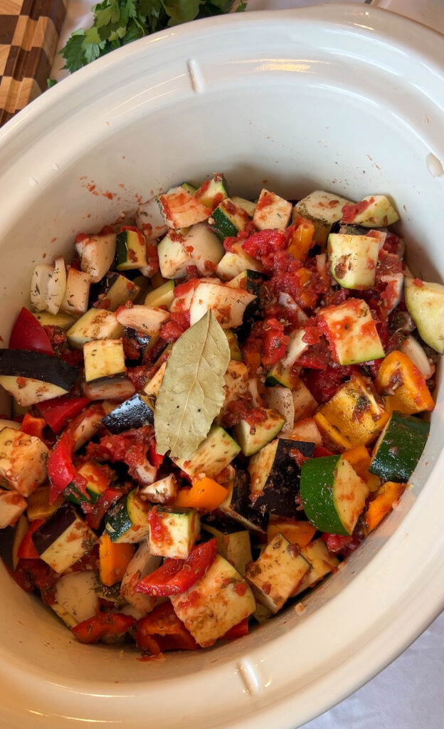 Mixing ingredients for crockpot ratatouille before cooking