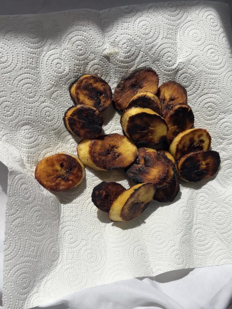 Fried sweet plantains draining on paper towels after frying