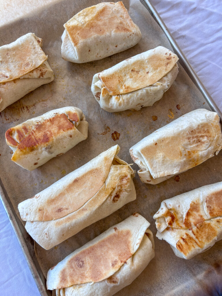 Crispy sheet pan breakfast burritos after baking