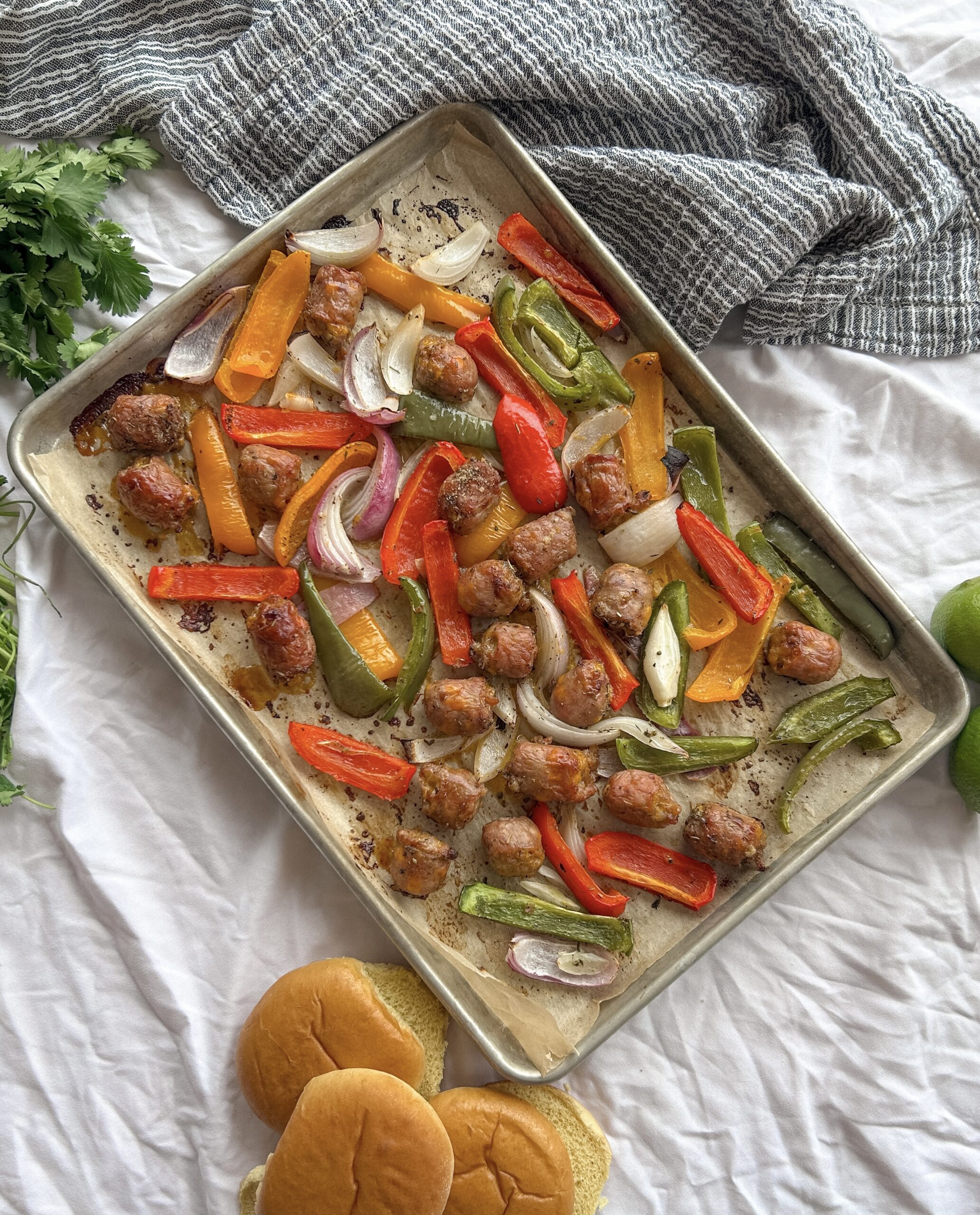 sheet pan sausage peppers and onions roasted with Italian sausage, bell peppers, and onions on a baking sheet