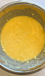 Whisking eggs and cottage cheese for sheet pan breakfast burritos