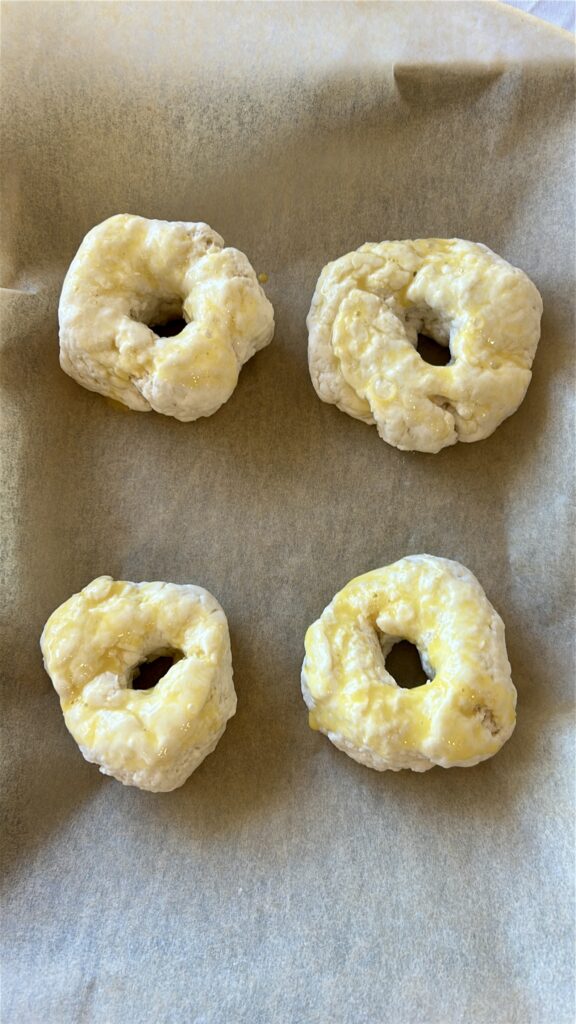 Brushing greek yogurt bagels with egg wash