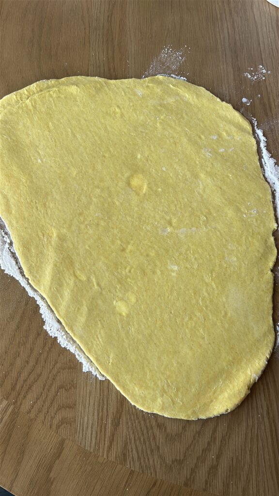 Rolling Jamaican meat pie dough to even thickness