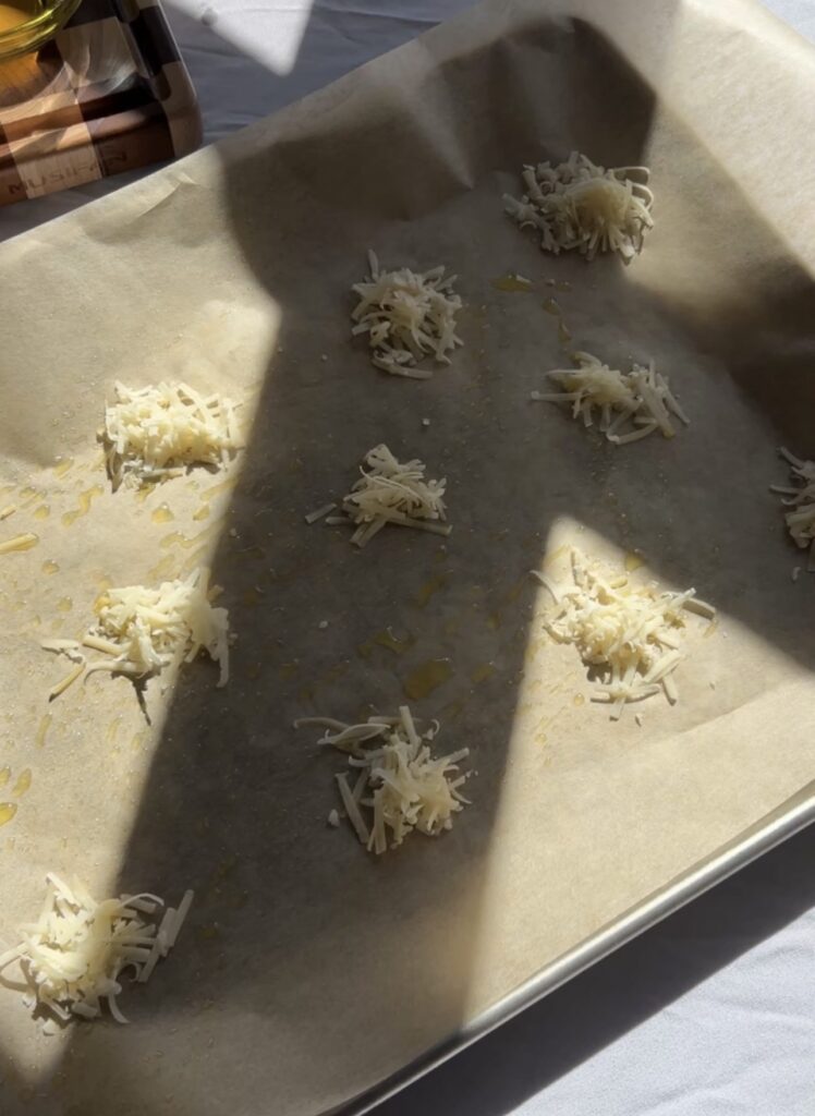 grated parmesan placed on parchment to create crispy cheese crust