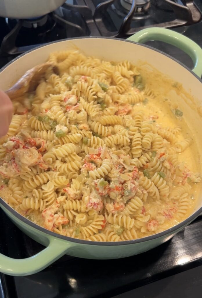 Tossing rotini in creamy Crawfish Monica sauce