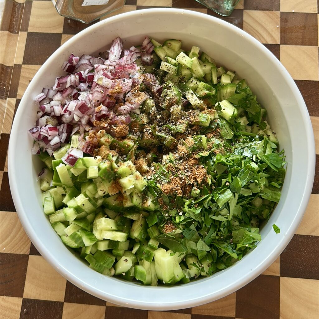 adding lemon dressing to salata baladi egyptian salad