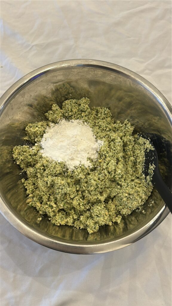 adding flour and baking powder to falafel mixture
