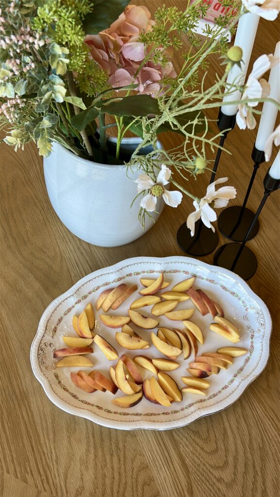Sliced peaches arranged on platter for peach caprese salad