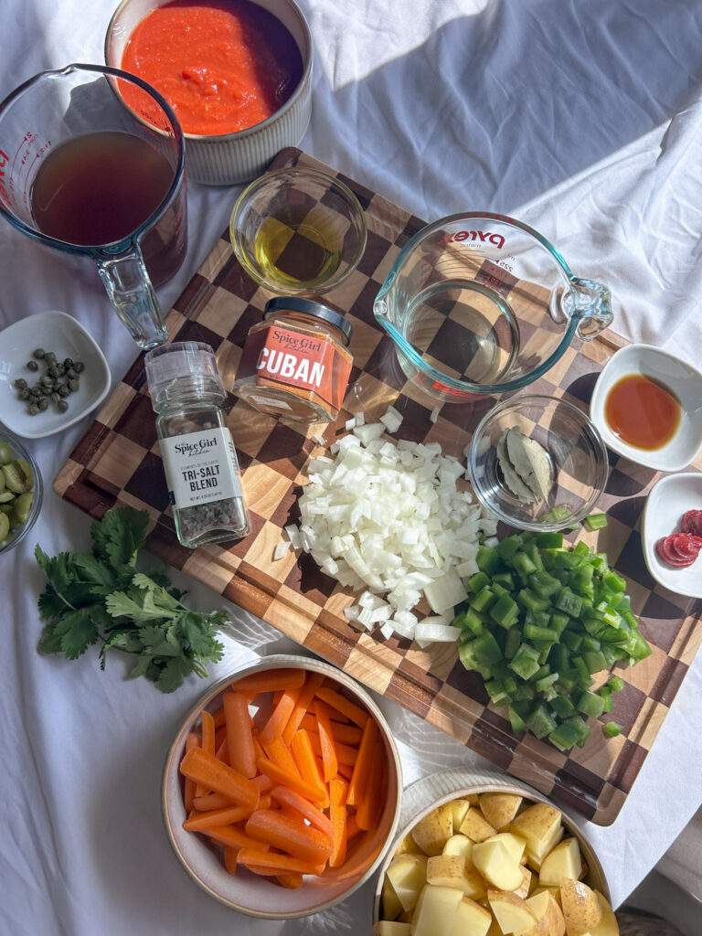 Ingredients for Cuban carne guisada including chuck roast, potatoes, olives, and tomato sauce