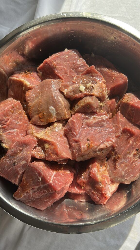 Marinating beef for Cuban carne guisada with citrus and Cuban seasoning