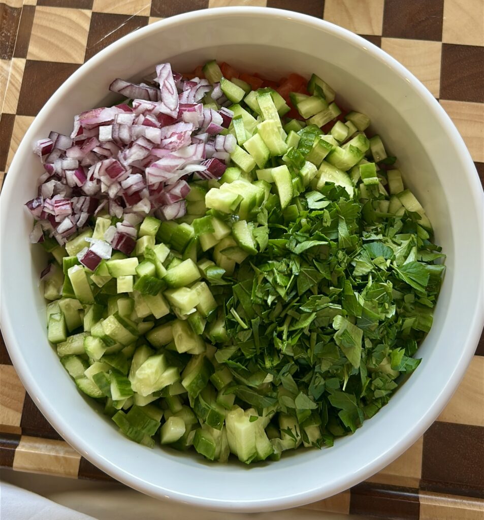 chopped tomatoes cucumbers onion and parsley for salata baladi egyptian salad