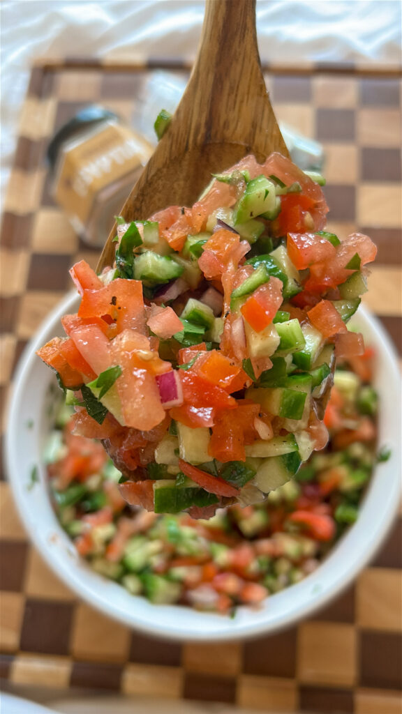close up of fresh salata baladi egyptian salad with chopped tomatoes cucumbers and parsley