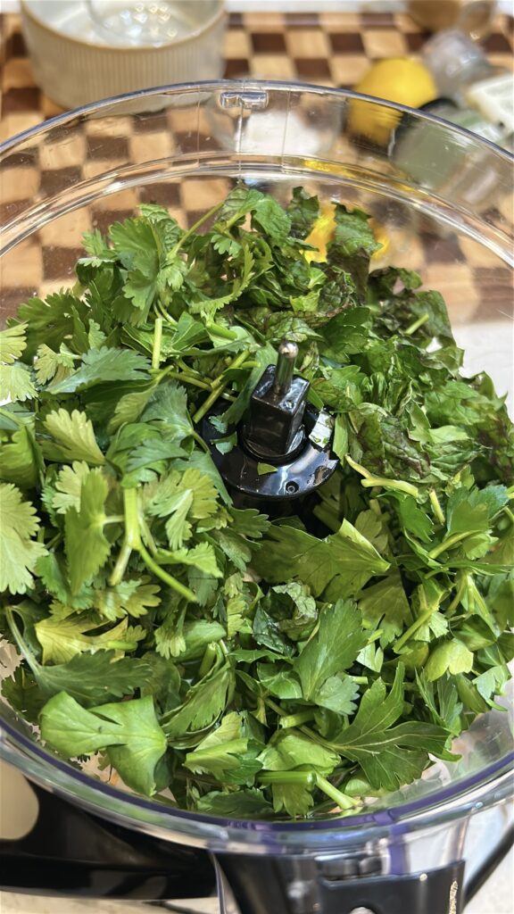 chickpeas herbs and onion in food processor for falafel