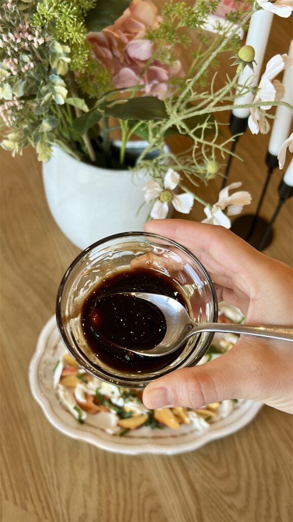 Mixing honey balsamic dressing for peach caprese salad