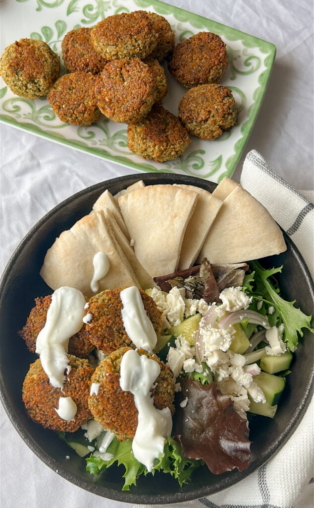 oven baked falafel pita with yogurt sauce and salad greens